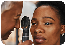 Ophthalmologist examines woman's eye