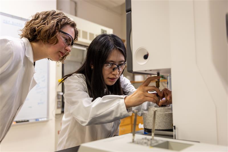 Researchers at microscope