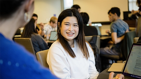 a female student smiling in the classroom