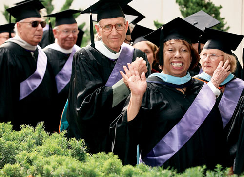 From right, Deonne Beasley Wright (C56) and George Ingram (WCAS56) proceeding to Commencement with classmates
